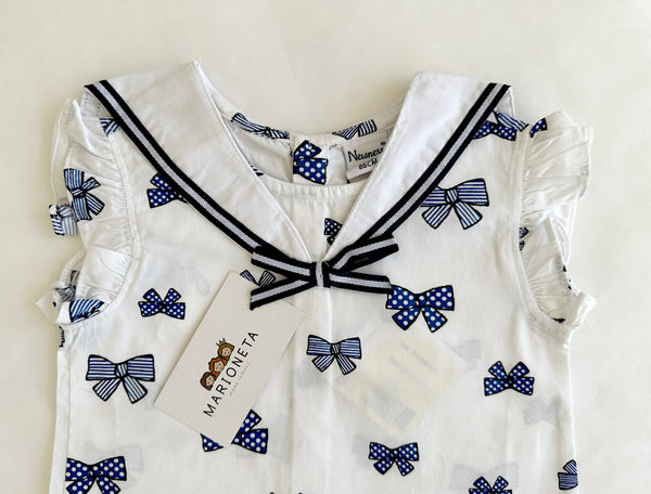 Conjunto dos piezas blusa blanca con estampado moños marino y short marino para bebe niña | Newness