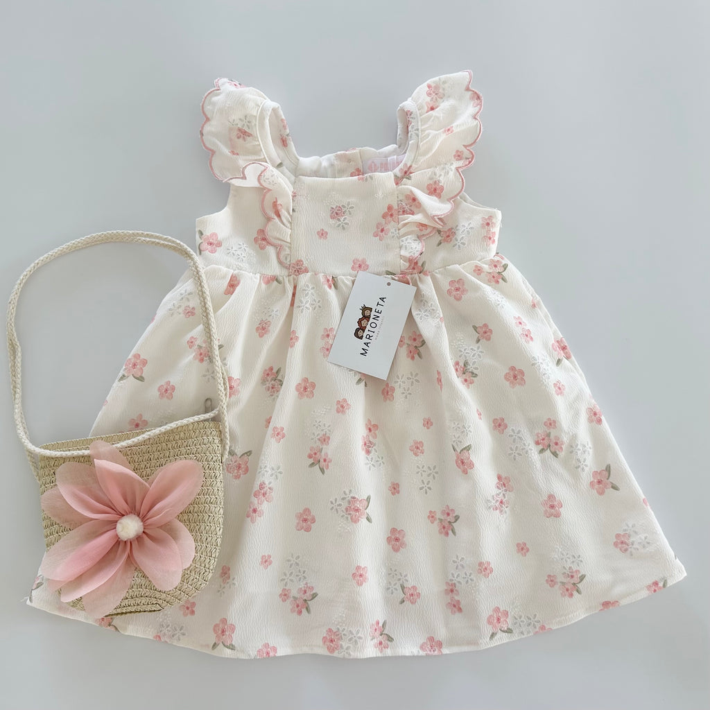 Vestido estampado de florecitas color rositas con olanes y  bolsa para niña .