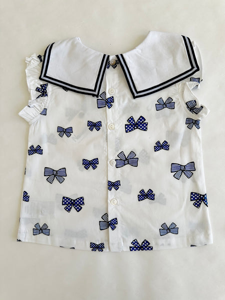 Conjunto dos piezas blusa blanca con estampado moños marino y short marino para bebe niña | Newness