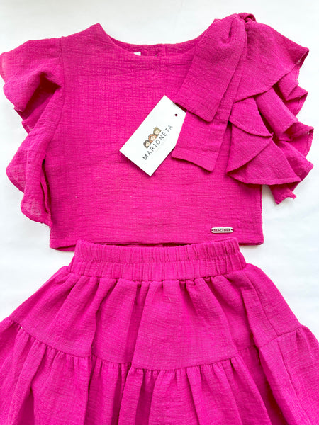 Conjunto dos piezas blusa y falda color rosa fiusha con adorno de lazo al hombro para niña |