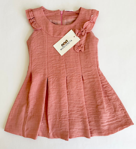 Vestido color palo de rosa con detalle de moños al frente para niña |