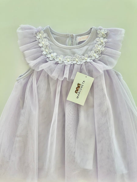 Vestido con florecitas blancas y olan al frente color morado lila para niña|