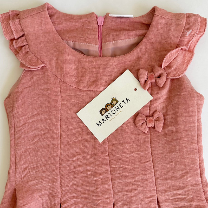 Vestido color palo de rosa con detalle de moños al frente para niña |