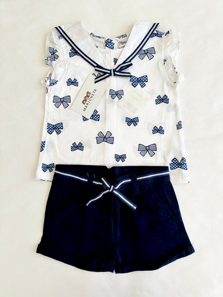 Conjunto dos piezas blusa blanca con estampado moños marino y short marino para bebe niña | Newness