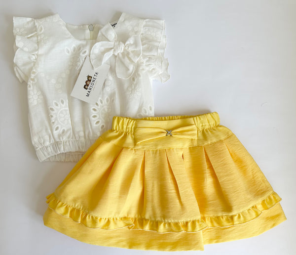 Conjunto dos piezas blusa blanca con detalle de moño y falda con olan color amarillo para niña.