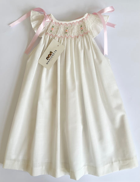 Vestido bordado hecho a mano jesucito color beige con bordado rosa y lazos en hombros para niña |