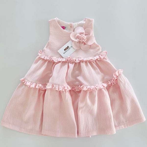Vestido de olanes color rosita con adorno de flor en el frente para niña |