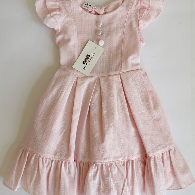 Vestido con detalle de botones y olanes color rosita para niña.