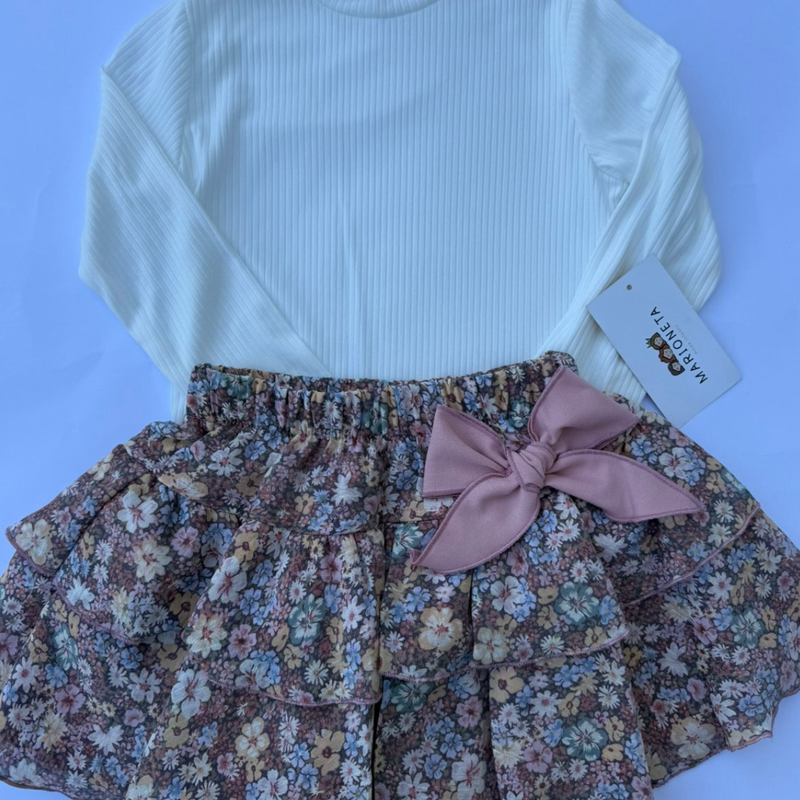 Conjunto tres piezas chamarra rosita, playera ivory y falda de olanes estampada de flores.