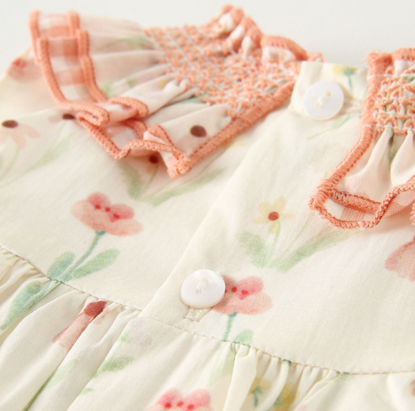 Vestido estampado color ivory con salmon, conb adorno de lazo al frente y braguita para bebe niña | NEWNESS