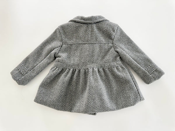 Abrigo color gris con adorno de lazos al frente para niña .|