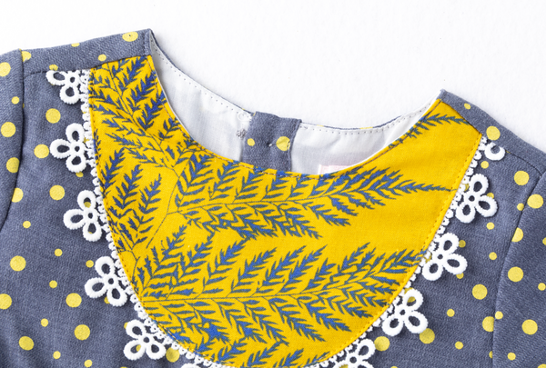 Vestido gris de puntos, combinado con amarillo manga larga para bebe niña |Newness .