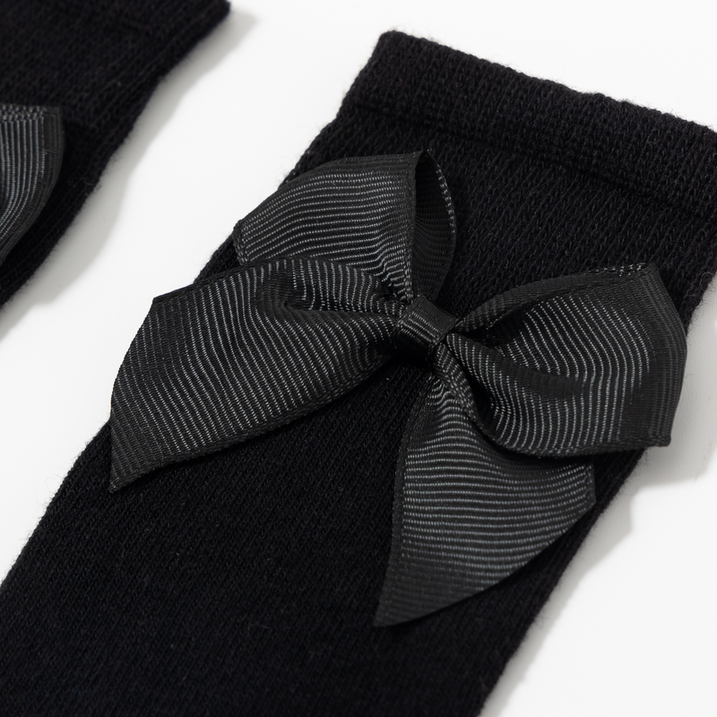 Medias con detalle de lazo color negro para niña | Newness