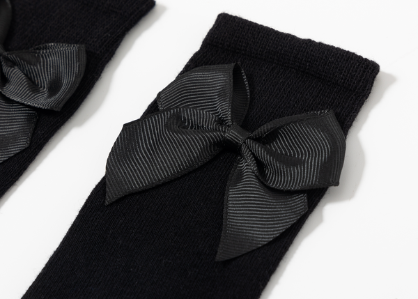 Medias con detalle de lazo color negro para niña | Newness